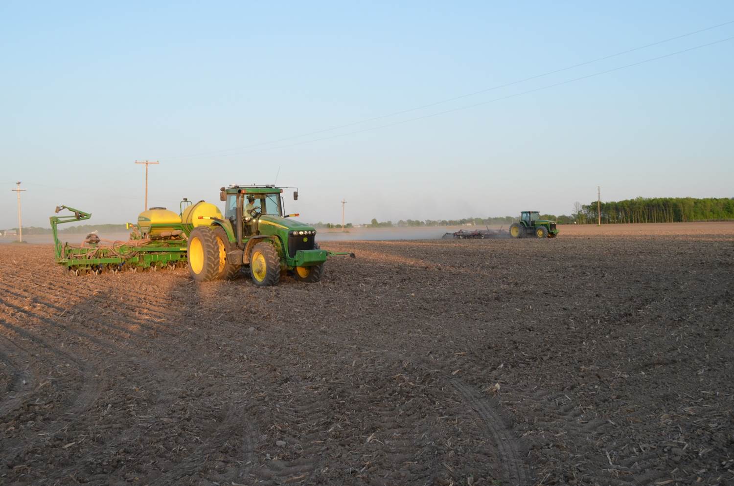 JD 8100 MFWD fitting ground in front of JD 8320 and JD 1790 planter